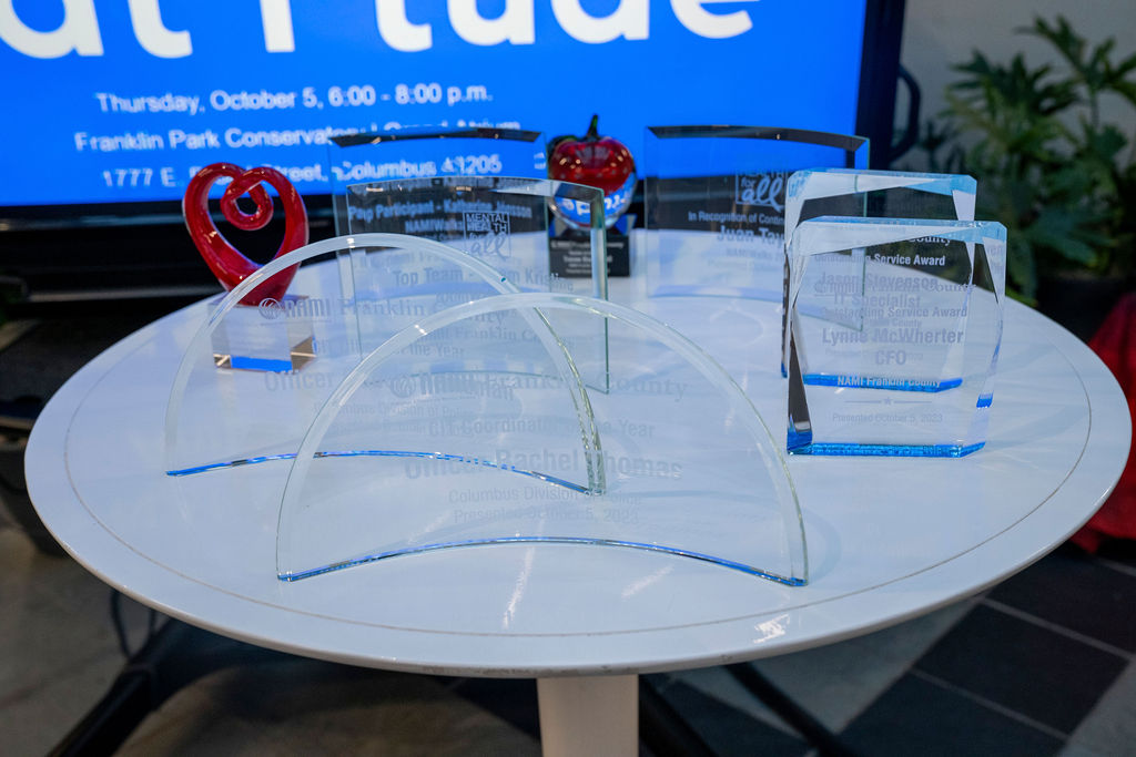 A table with two chairs and a glass top.